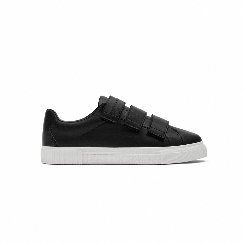 Sneakers. Fastens with three adhesive straps. White soles. Never used